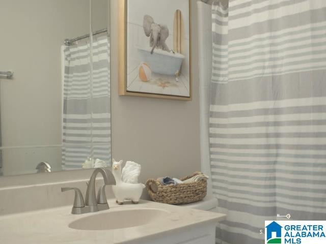 bathroom featuring curtained shower and vanity