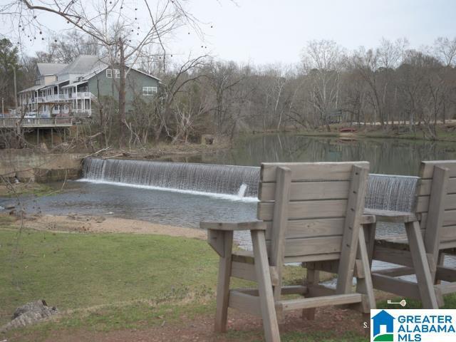 exterior space featuring a water view and a lawn