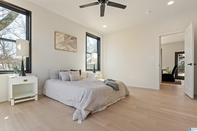 bedroom featuring recessed lighting, ceiling fan, light wood-style flooring, and baseboards