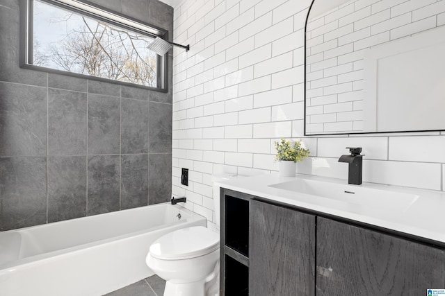 full bathroom featuring decorative backsplash, toilet, shower / tub combination, vanity, and tile walls