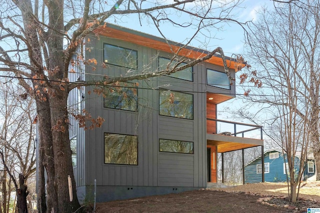 view of property exterior with crawl space and a balcony