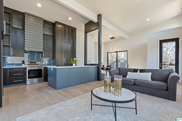 living room featuring light wood finished floors, beam ceiling, and recessed lighting