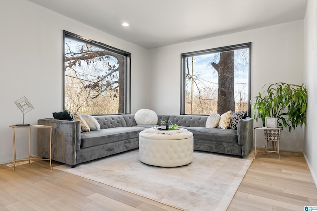 living area with light wood finished floors and recessed lighting