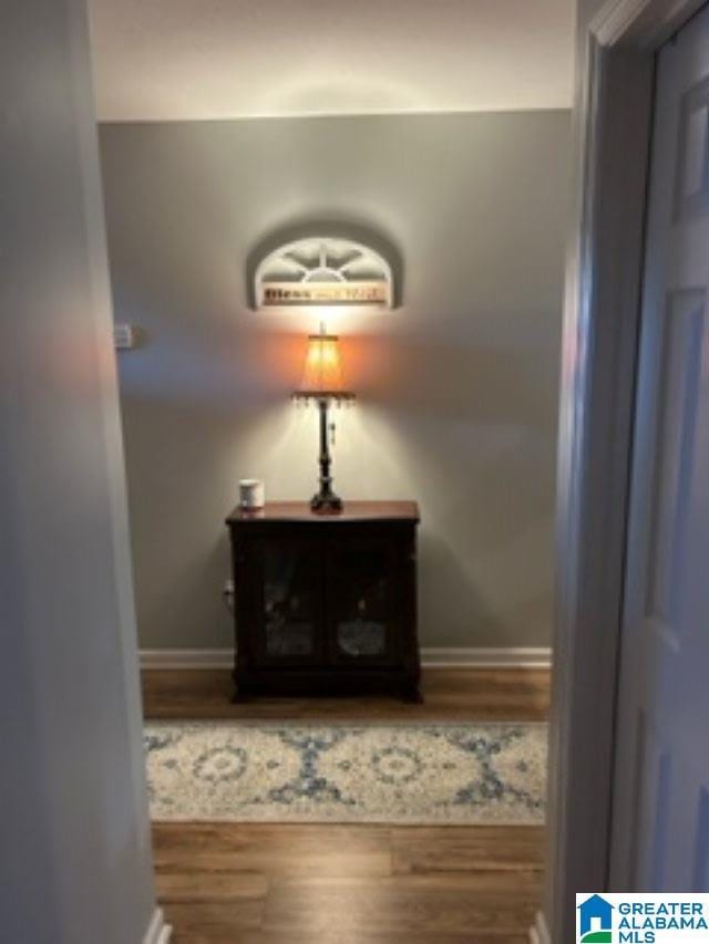 room details featuring baseboards and wood finished floors