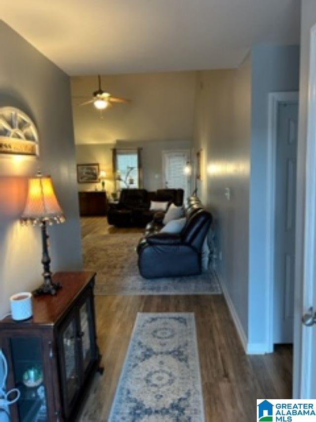 interior space with baseboards and wood finished floors