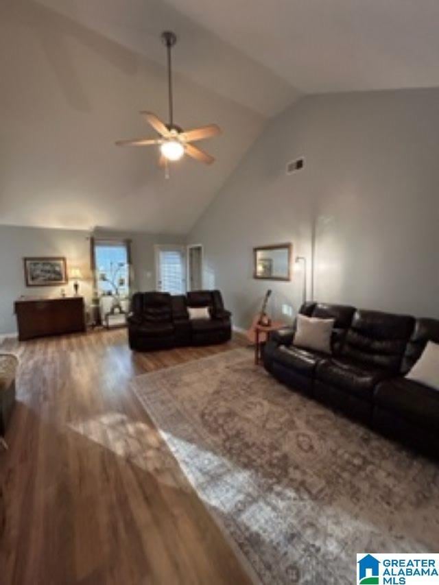 living room featuring ceiling fan, high vaulted ceiling, wood finished floors, and visible vents