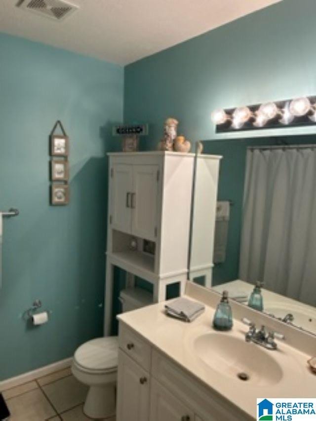 full bath with tile patterned flooring, toilet, vanity, visible vents, and baseboards