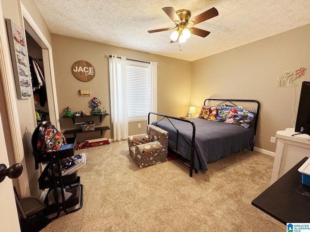 bedroom with carpet floors, ceiling fan, a textured ceiling, and baseboards