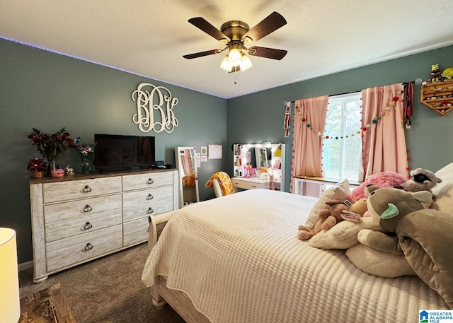 bedroom with dark colored carpet and a ceiling fan