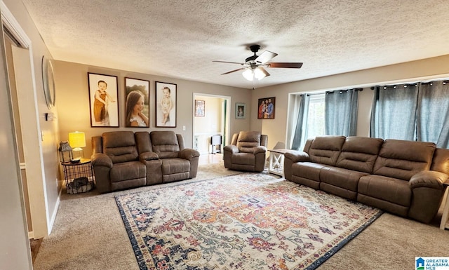 carpeted living room featuring a ceiling fan, a textured ceiling, and baseboards