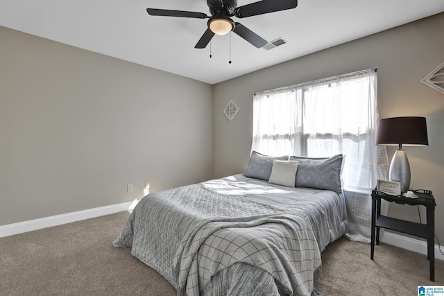 bedroom with baseboards, visible vents, ceiling fan, and carpet flooring