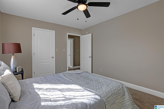 carpeted bedroom featuring ceiling fan and baseboards