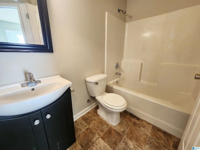 bathroom with toilet, baseboards,  shower combination, and vanity