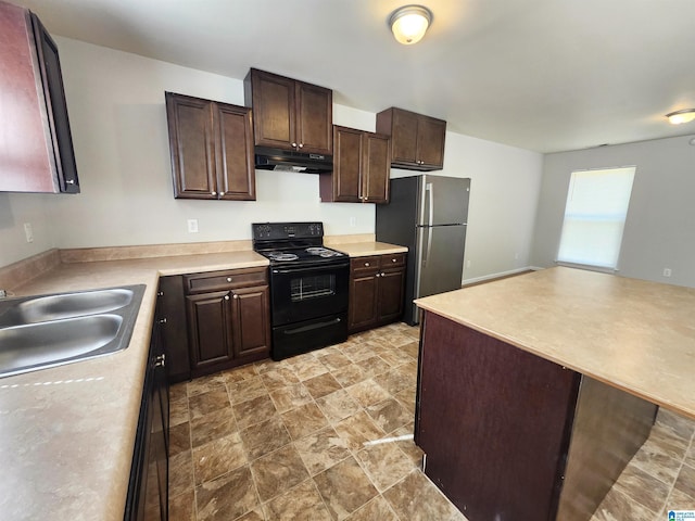 kitchen featuring black electric range, light countertops, freestanding refrigerator, a sink, and under cabinet range hood