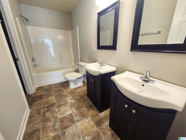 bathroom with shower / bath combination, two vanities, a sink, and toilet