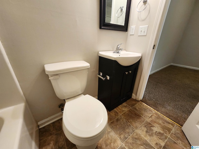 bathroom with baseboards, vanity, and toilet