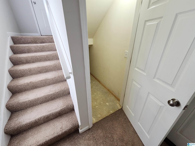 stairway featuring carpet and baseboards