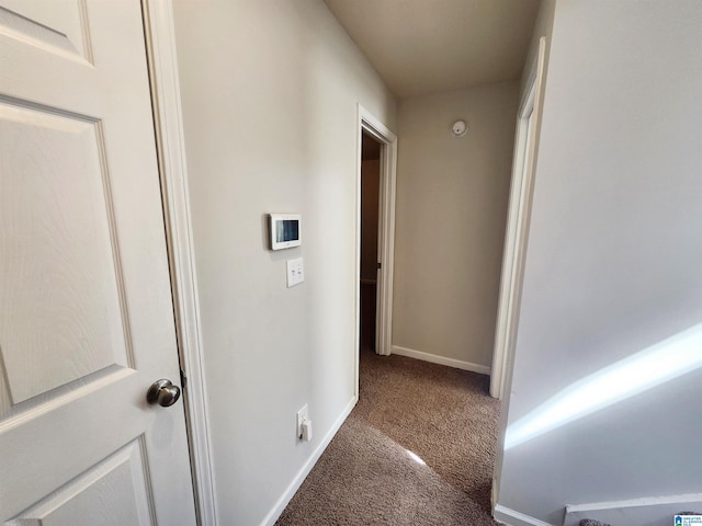 corridor with carpet floors and baseboards