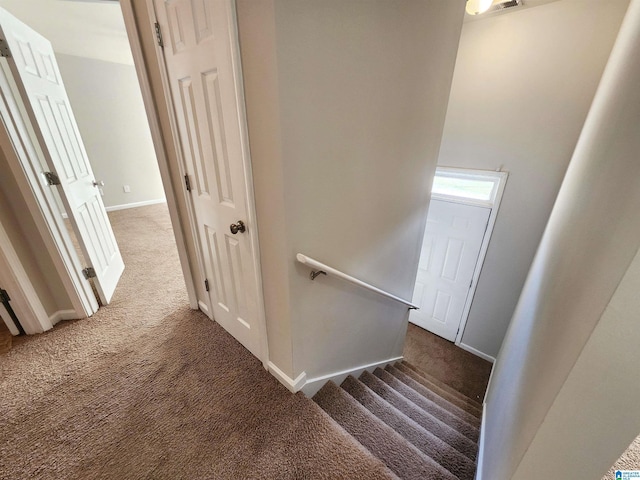 staircase with carpet and baseboards