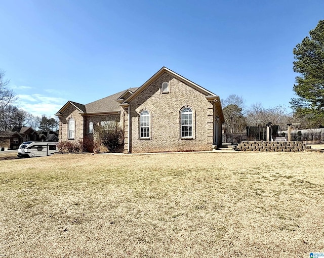 view of front of house with brick siding and a front lawn