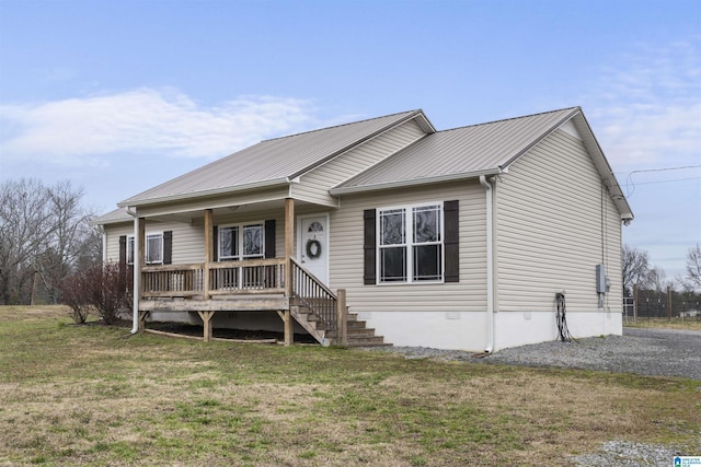 view of front of house featuring metal roof, a porch, a front lawn, and crawl space