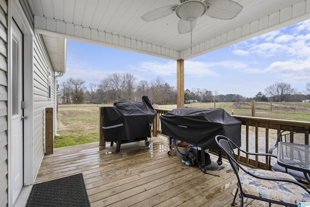 deck featuring a grill, ceiling fan, and a rural view