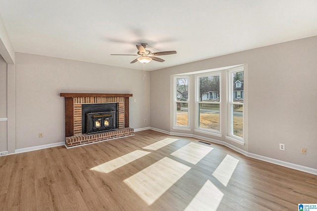 unfurnished living room featuring light wood finished floors, baseboards, and visible vents