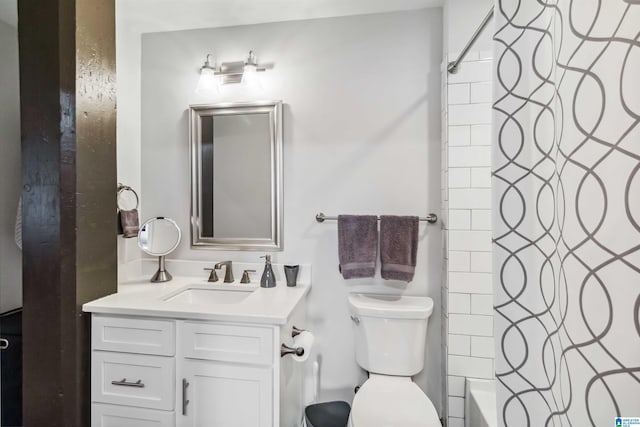 bathroom featuring toilet, shower / bathtub combination with curtain, and vanity