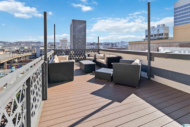 wooden terrace with an outdoor living space and a city view