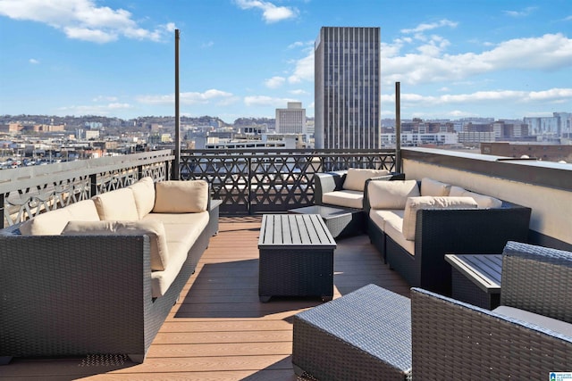 wooden deck featuring outdoor lounge area and a city view