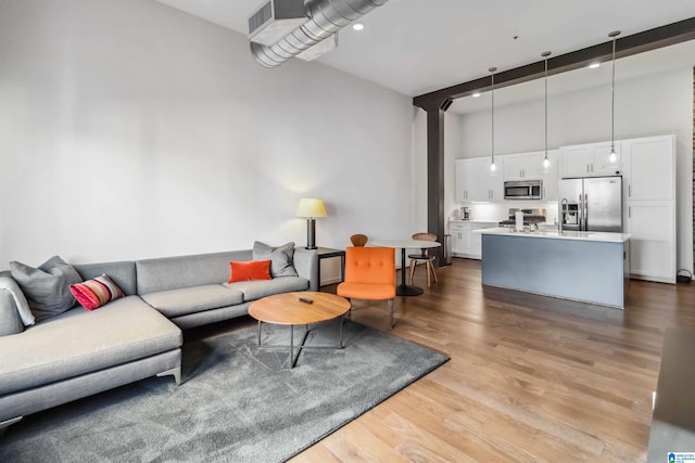 living room with light wood-type flooring and visible vents