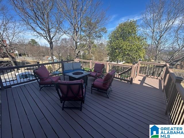 wooden deck with an outdoor fire pit