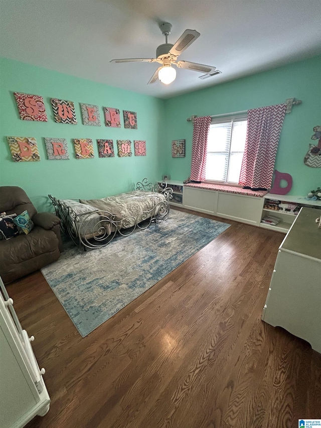 bedroom with a ceiling fan and dark wood-style flooring