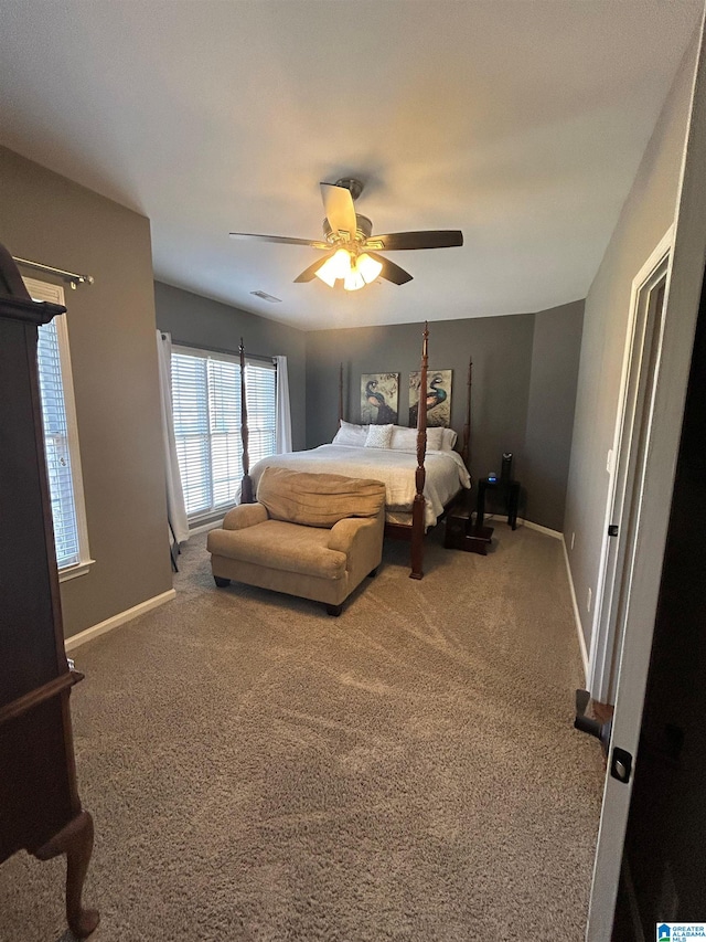 carpeted bedroom with a ceiling fan and baseboards