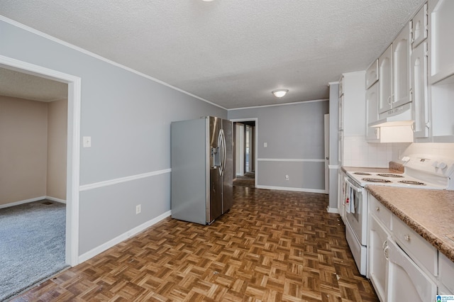 kitchen featuring electric stove, light countertops, stainless steel fridge, and white cabinetry