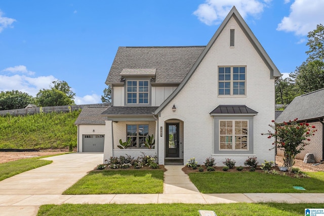 view of front of house featuring concrete driveway, brick siding, roof with shingles, and a front yard