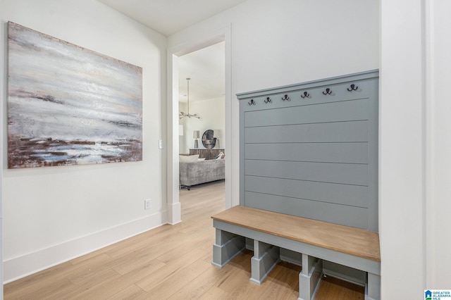 mudroom with baseboards and wood finished floors