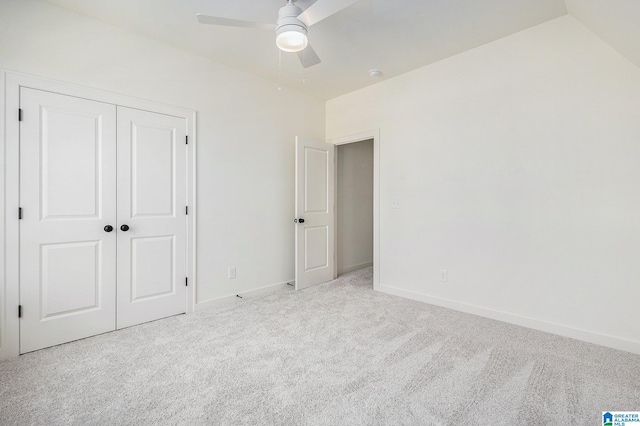 unfurnished bedroom featuring ceiling fan, baseboards, a closet, and light colored carpet