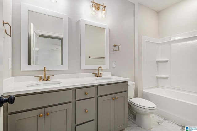 full bath with washtub / shower combination, marble finish floor, a sink, and toilet