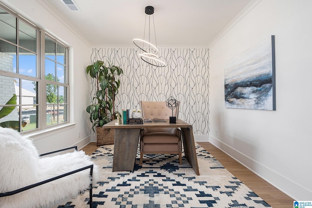 office with an accent wall, ornamental molding, visible vents, and baseboards