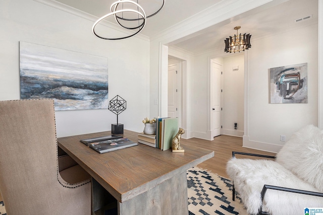 office area with light wood finished floors, a notable chandelier, visible vents, and crown molding