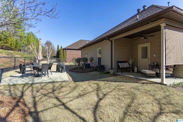 rear view of property featuring a patio, roof with shingles, fence, and a ceiling fan