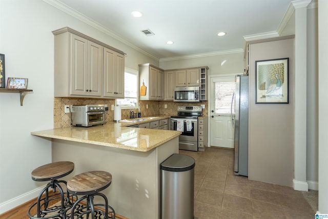 kitchen with stainless steel appliances, tasteful backsplash, a peninsula, and visible vents