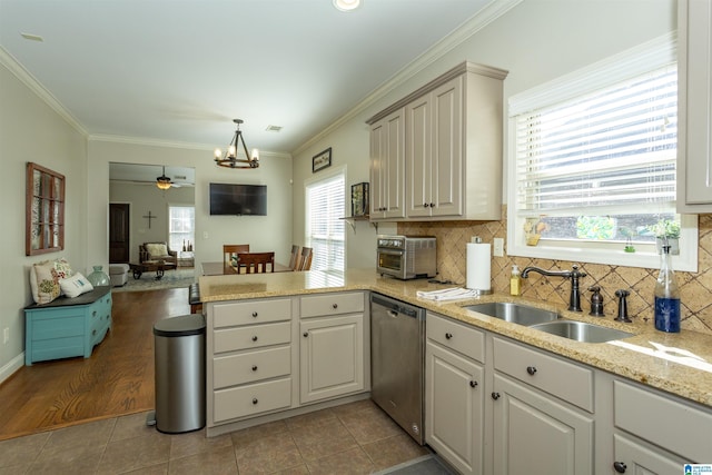 kitchen featuring light tile patterned floors, a peninsula, a sink, ornamental molding, and dishwasher