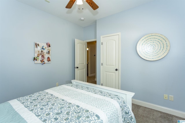 carpeted bedroom featuring ceiling fan and baseboards