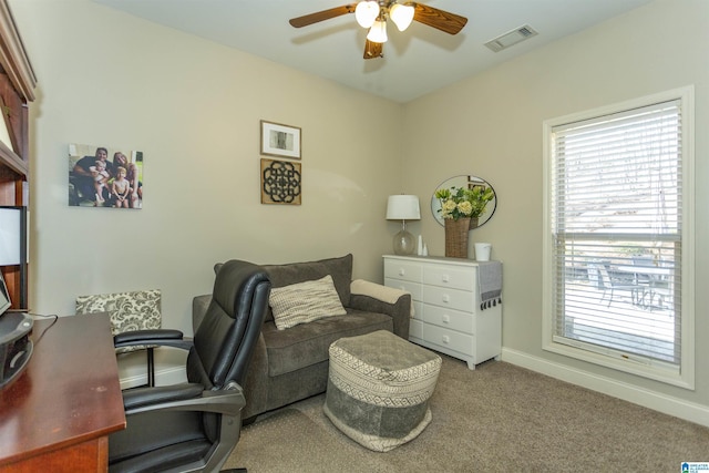 office featuring baseboards, ceiling fan, visible vents, and carpet flooring