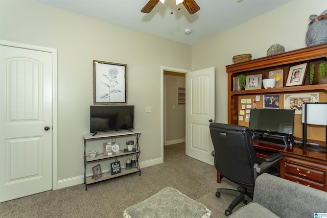 home office featuring carpet floors, baseboards, and a ceiling fan