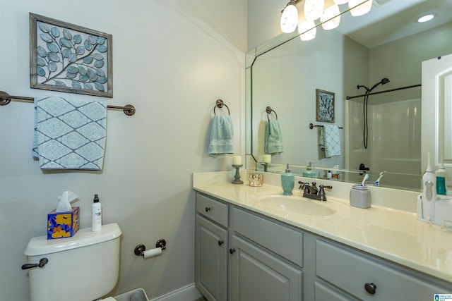 full bathroom with visible vents, toilet, vanity, baseboards, and walk in shower