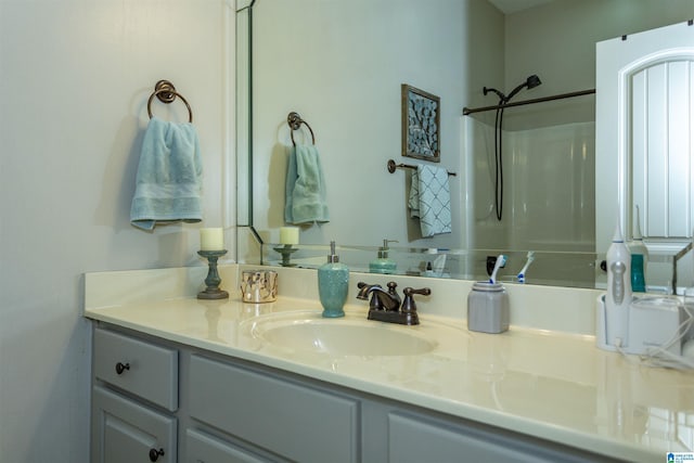 full bath featuring a shower and vanity