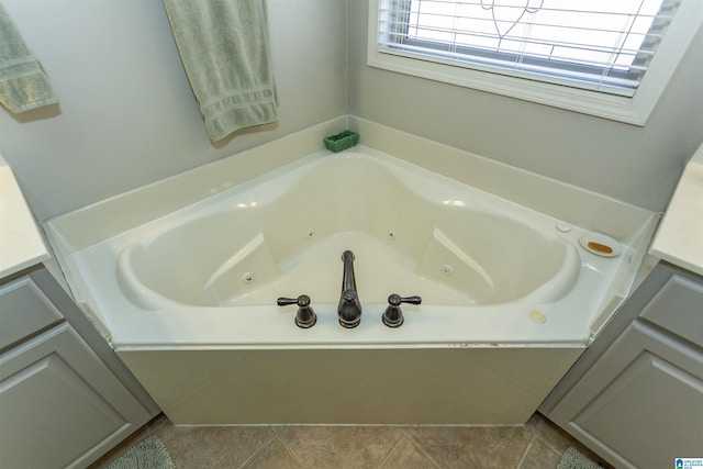 bathroom with a whirlpool tub and vanity